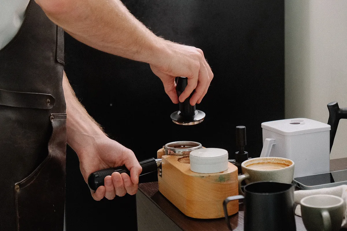 Tamping espresso during a class