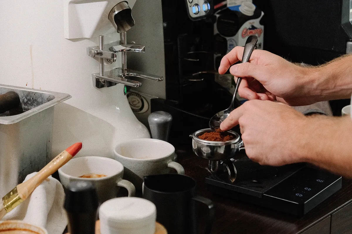 Dosing ground coffee into a portafilter