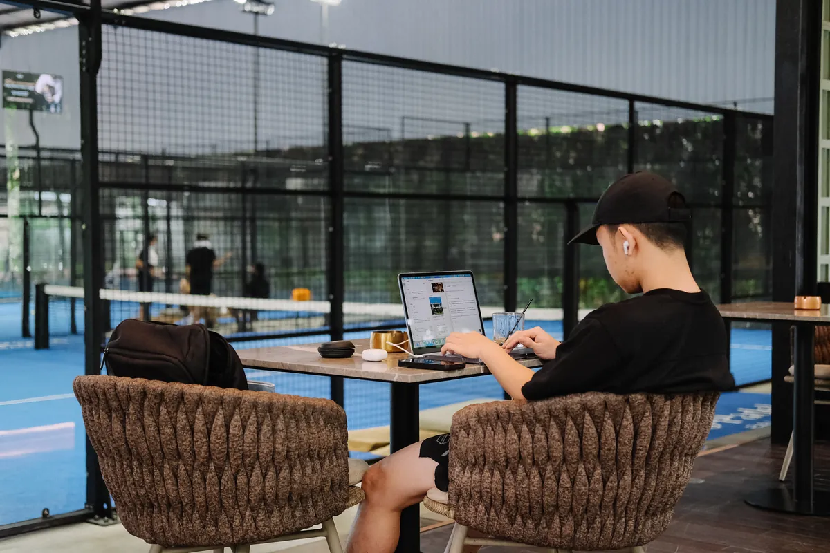A guest working beside the padel courts