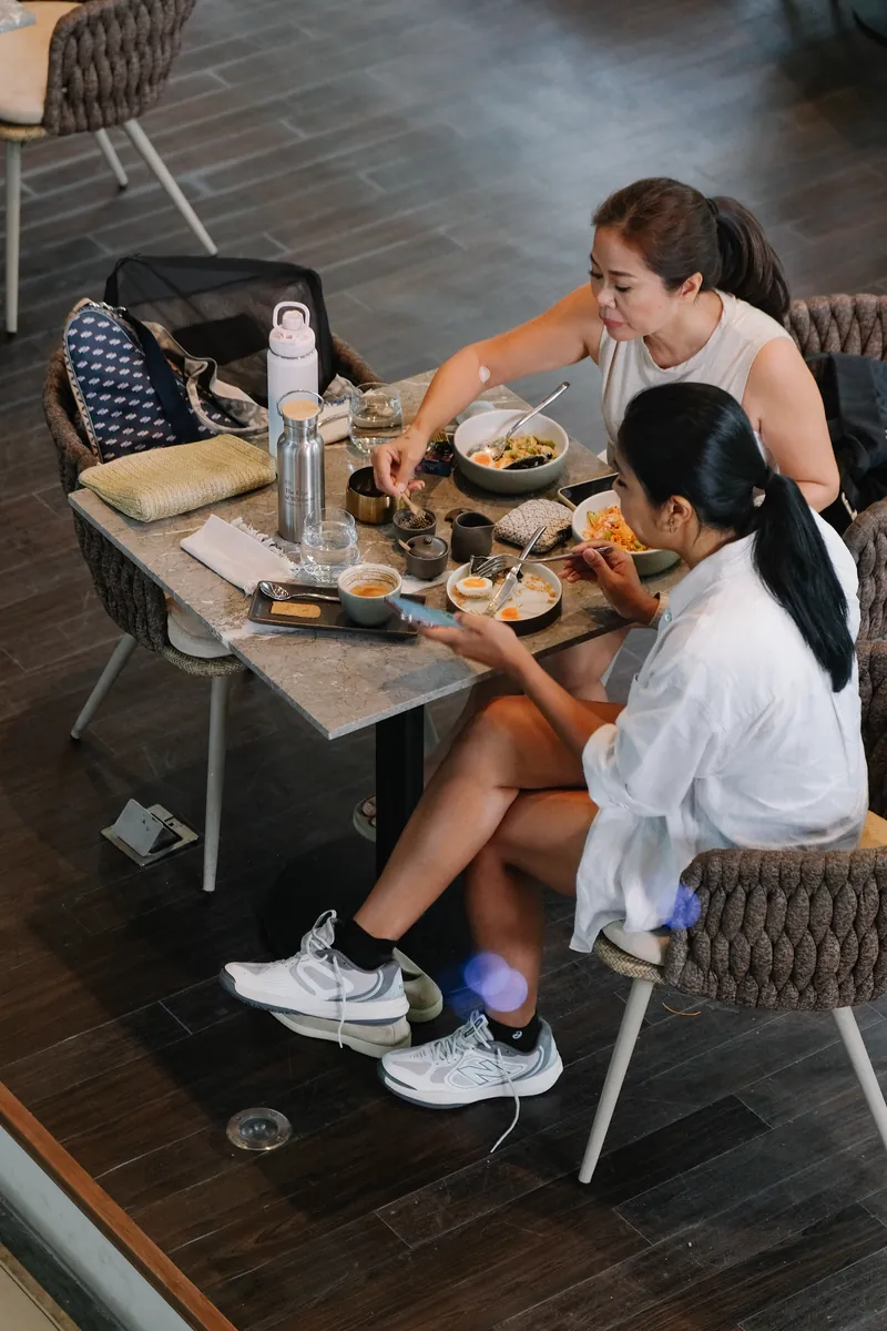Two friends sharing lunch at Meet me Cafe